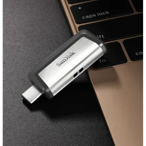 فلش‌مموری سن‌دیسک مدل Ultra Dual Drive USB Type-C ظرفیت 32 گیگابایت با دو درگاه USB3.1 و USB Type-C، سرعت انتقال تا 130 مگابایت بر ثانیه، قابلیت اتصال به گوشی و تبلت، طراحی جمع‌وجور و بدنه ترکیبی فلز و پلاستیک