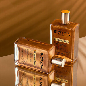 روغن خشک درخشان‌کننده بیوکسین مدل GOLD ON SKIN مناسب صورت، بدن و مو  با ذرات اکلیلی طلایی حجم ۱۰۰ میل