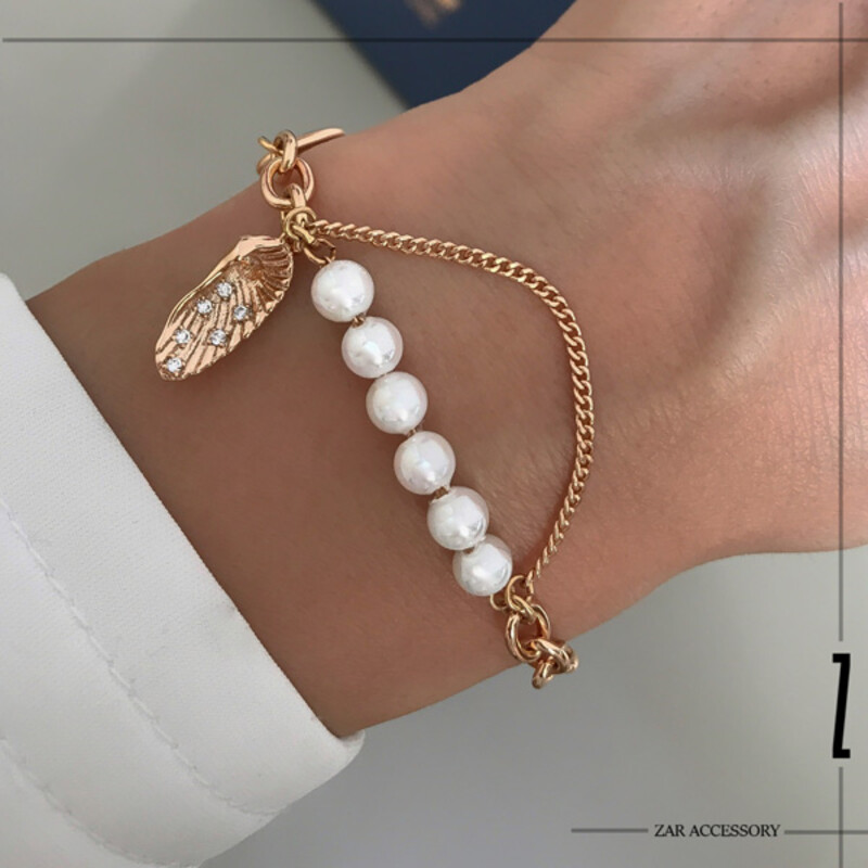 دستبند زنانه مروارید و بال پرنده