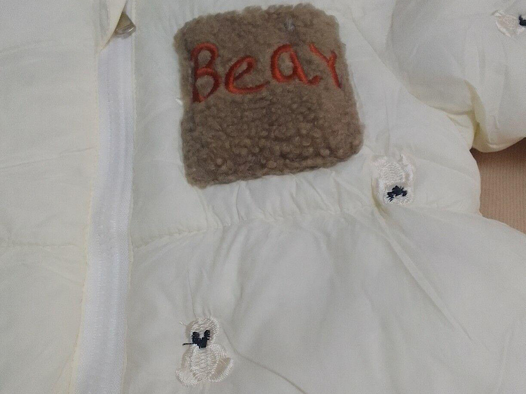 کاپشن سرهمی لاینردار و کلاه دار نوزادی شیری رنگ با طرح گلدوزی