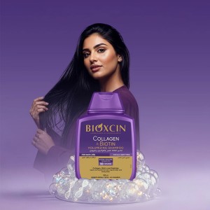 بطری بنفش شامپو بیوکسین کلاژن و بیوتین با درب فلیپ‌تاپ و برچسب طلایی، نمای روبه‌رو